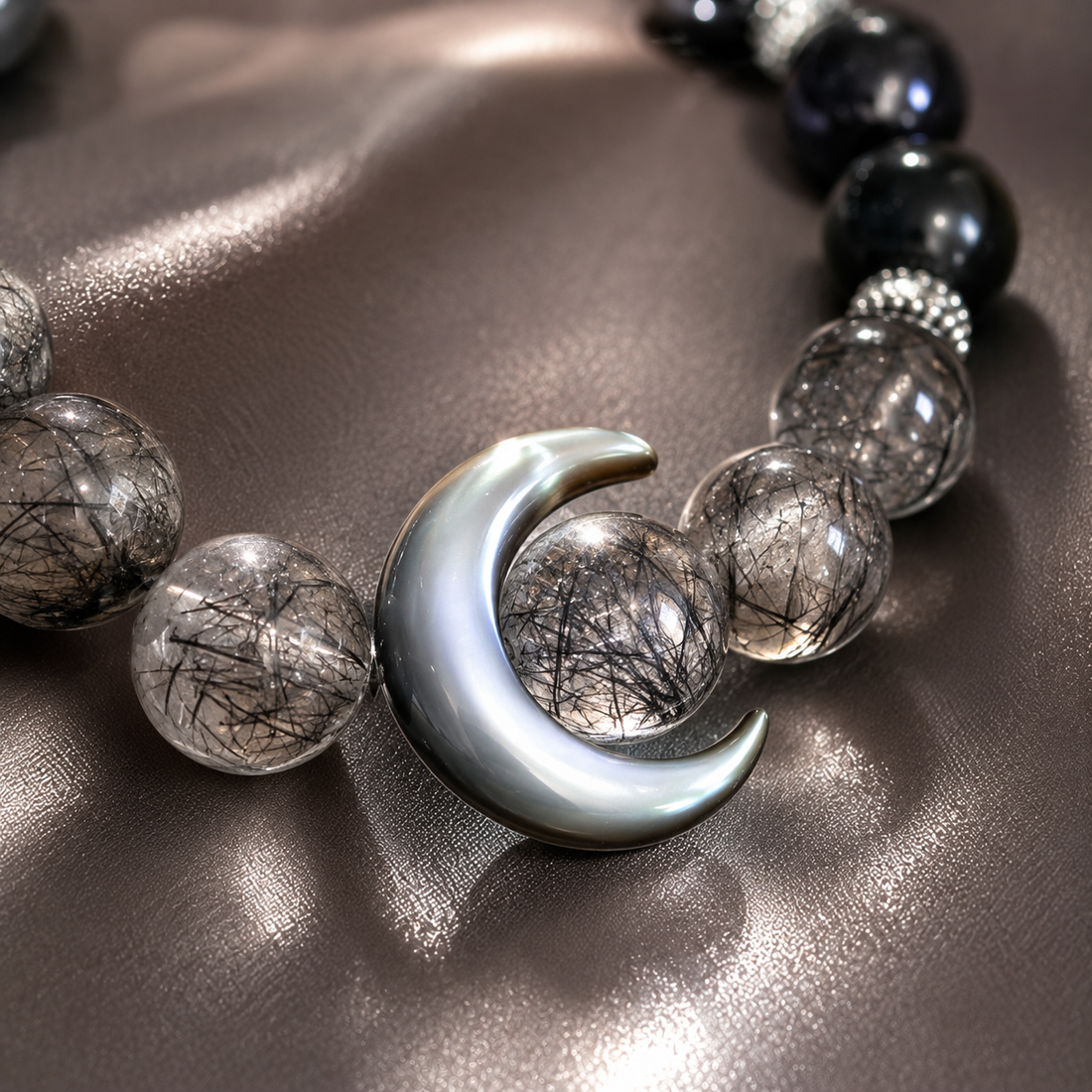 Black Hair Crystal Moon Bracelet care and maintenance showing natural rough stone beads requiring regular energetic cleansing